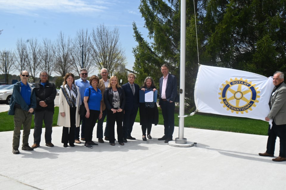 Members of the Newmarket Rotary Club gather to raise the flag on its 40th anniversary. From left, Peter Ginsberg, Azhar Saleem, assistant district governor Fran Taylor, treasurer Adam Dellecese, Vita Lobo, Victoe Woodhouse, Janet Richards, Deputy Mayor Tom Vegh, Rotary president Laura Bradford, Mayor John Taylor, district governor John Burns. 