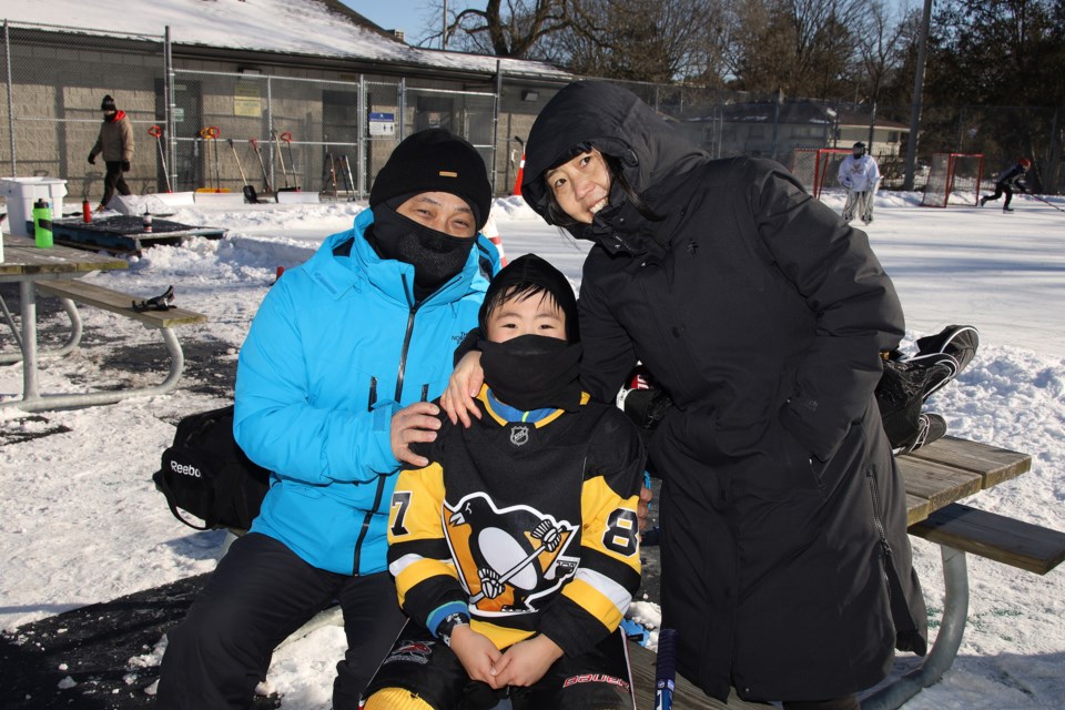 Jim Lee (from left), son Matthew and wife Sewon drop by the Lions Park Community Hockey Rink, before heading out to go snowboarding.  Greg King for NewmarketToday