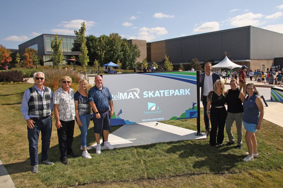 At the new sign for the telMAX Outdoor Skatepark at the Magna Centre are Councillor Victor Woodhouse (from left), Deputy Mayor Tom Vegh, Councillor Christina Bisanz, telMAX CEO Stuart Roberts, Mayor John Taylor, councillors Grace Simon and Kelly Broome, and telMAX vice-president of marketing Meg Shephard.  Greg King for NewmarketToday