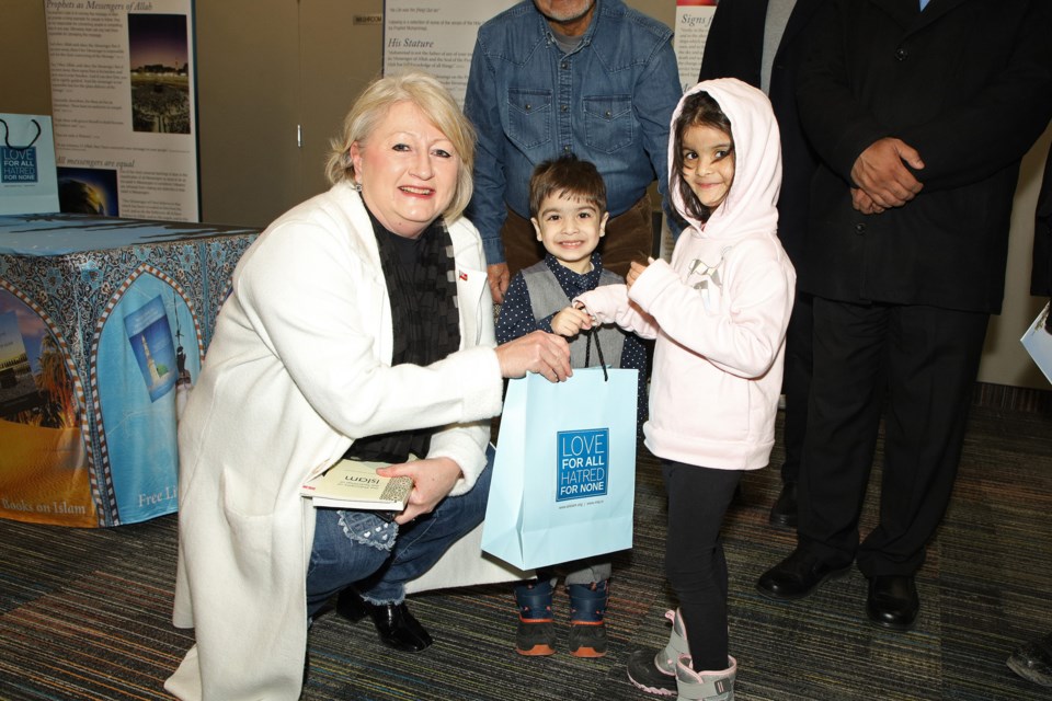 Newmarket-Aurora MPP Dawn Gallagher Murphy receives a gift from Zahran and Mahrosh Siddiqui at the Explore Islam exhibit at the Newmarket Public Library Sunday, hosted by the Newmarket chapter of the Ahmadiyya Muslim Youth Association Canada.  Greg King for NewmarketToday