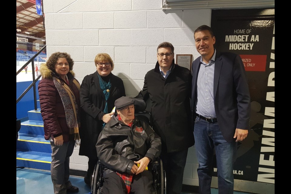 Jim Wells Sr., surrounded by his children, Heather Wells-Kemper, Lisa Wells-Lasitz and Jim Wells Jr., with Mayor John Taylor beside the unveiled dressing room plaque at the Ray Twinney Recreation Complex Dec. Julia Galt for NewmarketToday