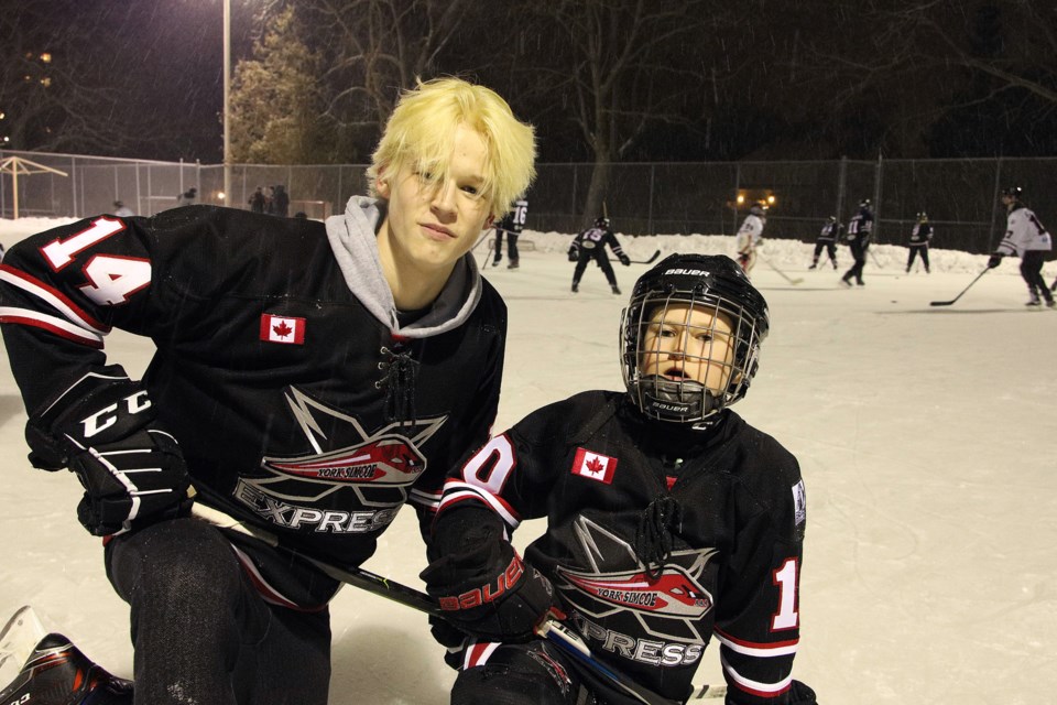 York Simcoe Express Minor Midget player Wylie Birkett, with 'little brother' Novice Quinn King, take part in the shinny game last night at Newmarket's Lions Park as part of the organization's mentorship program. Greg King for NewmarketToday