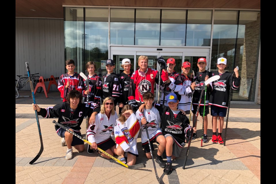 Newmarket Deputy Mayor Tom Vegh (back, centre) and Jackie Tranter (front, second from the left) with local hockey players.