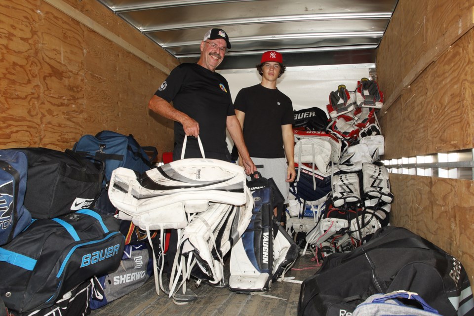 Drive founder Graham McWaters and Richmond Hill Coyote James Green load the truck at the Magna Centre Sept. 17 for the second annual  York Simcoe Express hockey equipment drive for Indigenous communities. 
Greg King for NewmarketToday