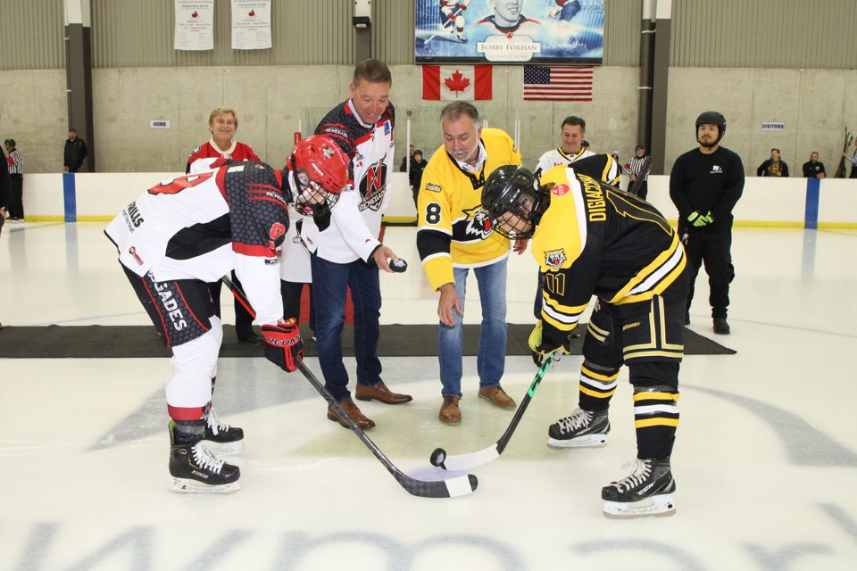 Newmarket Mayor John Taylor and Aurora Mayor Tom Mrakas drop the ceremonial puck Friday, Oct. 21 to start the annual rivalry showdown known as the Battle of Yonge Street.  Greg King for NewmarketToday