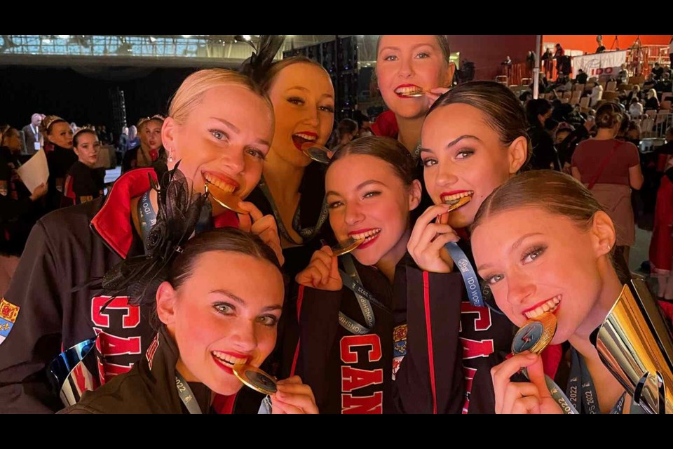 Team Canada dancers check out their gold medals. 