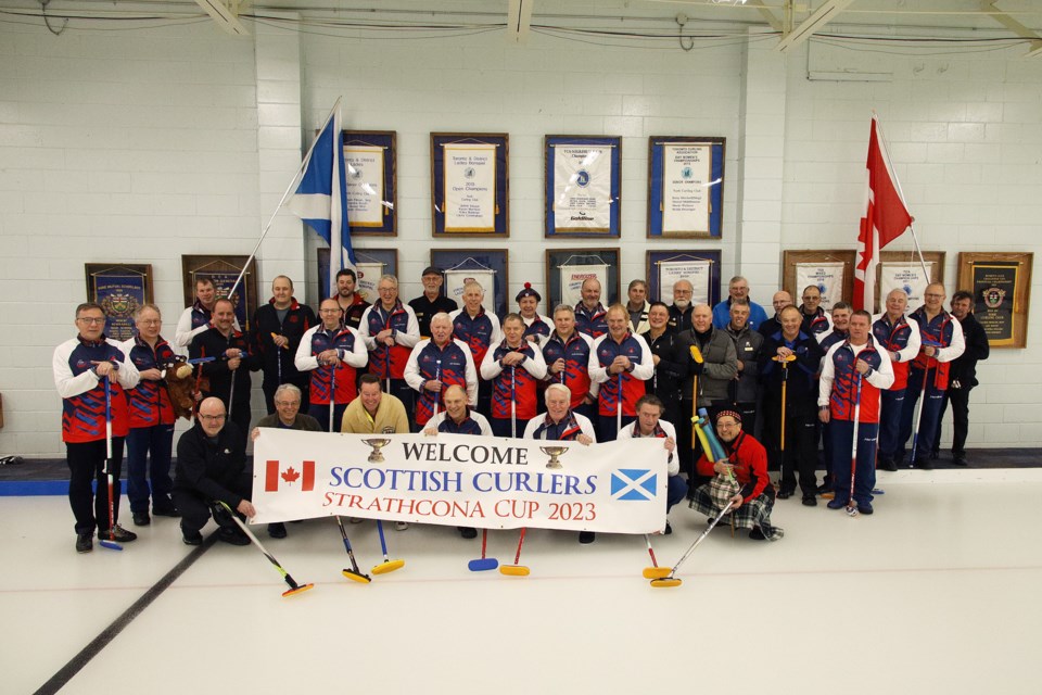The teams gather for a photo to mark the first occasion that the York Curling Club in Newmarket has hosted curlers from Scotland as part of the historic Strathcona Cup tour.  Greg King for NewmarketToday