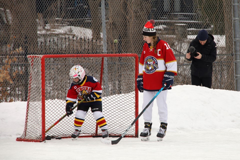 Filmmaker Randy Frykas visits the Lions Park community hockey rink this weekend to spotlight it as part of a documentary series. Here he films local hockey star Abby Lunney giving tips to Scarlett Kwak.  Greg King for NewmarketToday