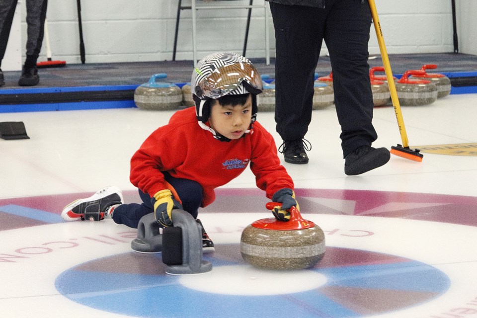 Little Rocks' Edward Wu readies to throw his stone at the season finals at the York Curling Club in Newmarket April 6. The kids throw regular stones but only play four ends.  Greg King for NewmarketToday