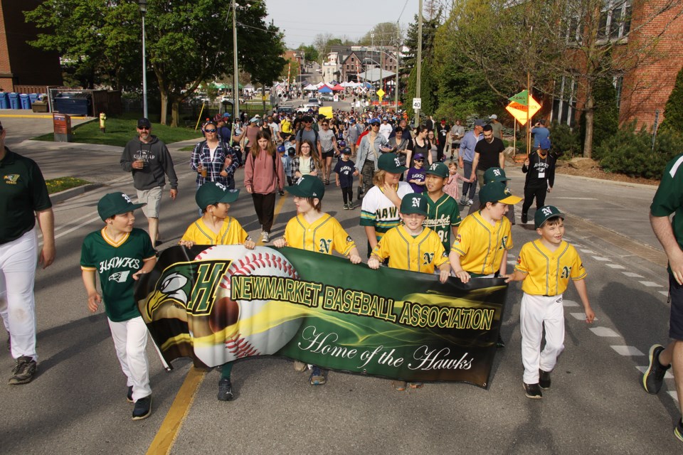 Hundreds of Newmarket Baseball Association players and their families marched along Timothy Street Saturday morning to the Fairgrounds for the opening day celebrations.  Greg King for NewmarketToday