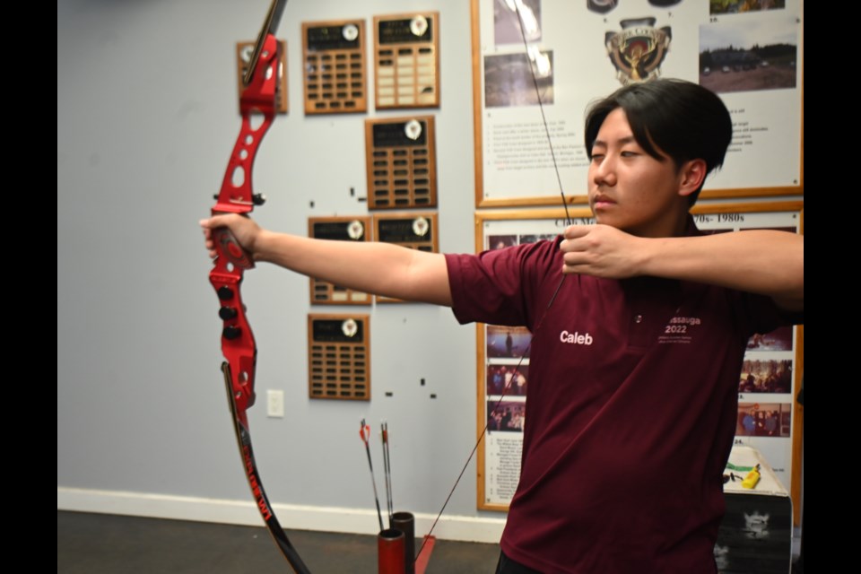 Newmarket archer Caleb Ko practises with a bow. Ko was honoured by the town Nov. 21.