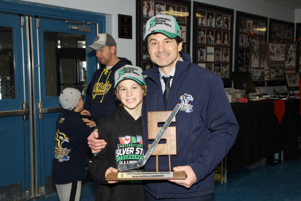 Braden Stringer of the Whitby Wildcats and his father, David, with the Minor Peewee AA trophy at the finals for the 34th Newmarket International Silver Stick hockey tournament at Ray Twinney Recreation Complex Jan 12.  Greg King for NewmarketToday