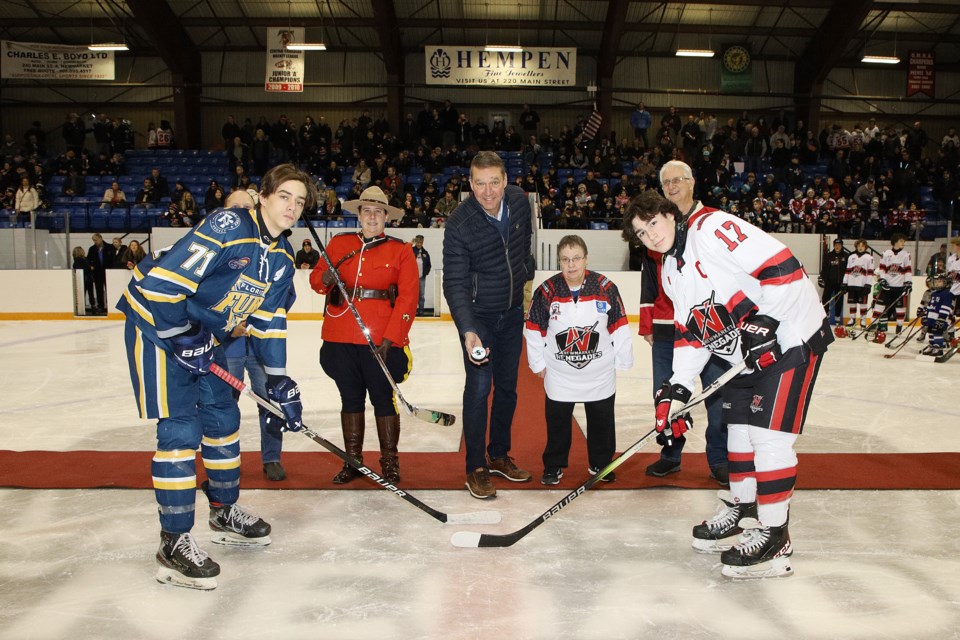 Newmarket Mayor John Taylor drops the puck for the 37th annual International Silver Stick tournament at Ray Twinney Recreation Complex Friday, with players representing the Florida Fury and Newmarket Renegades, Newmarket Minor Hockey Association president Lynda Carusi, Newmarket Councillor Trevor Morrison (far left), RCMP Const. Lisa Poff, and Newmarket Councillor Victor Woodhouse.