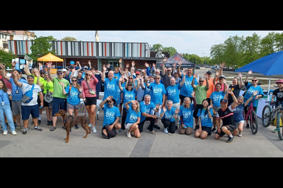 Newmarket cyclists pose for a group photo at Newmarket Bike Day June 1 at Riverwalk Commons.
