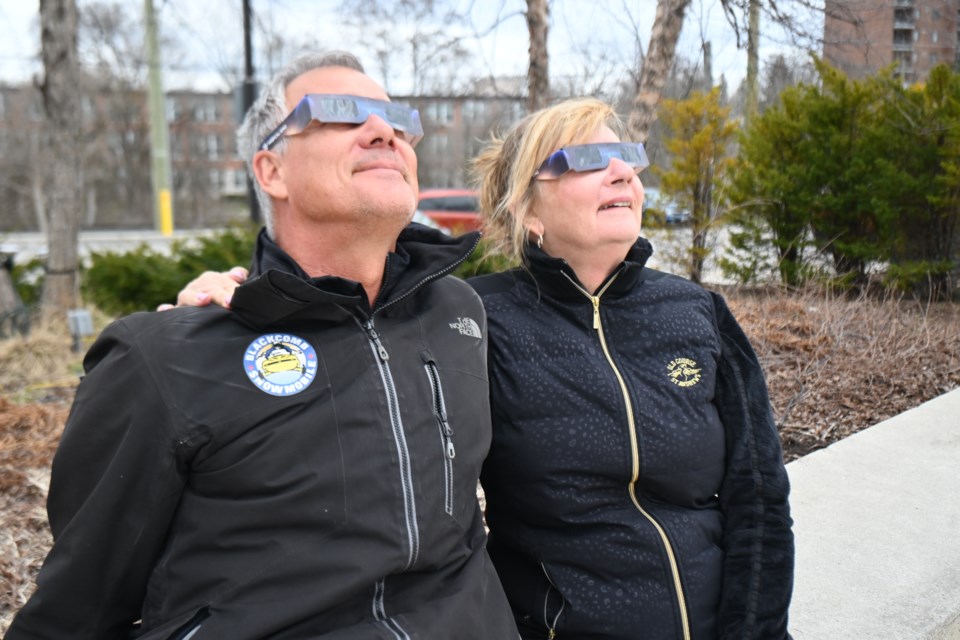Tim Van Halteren and Kelly Summerfeldt look up at the skies during the solar eclipse over Newmarket. 