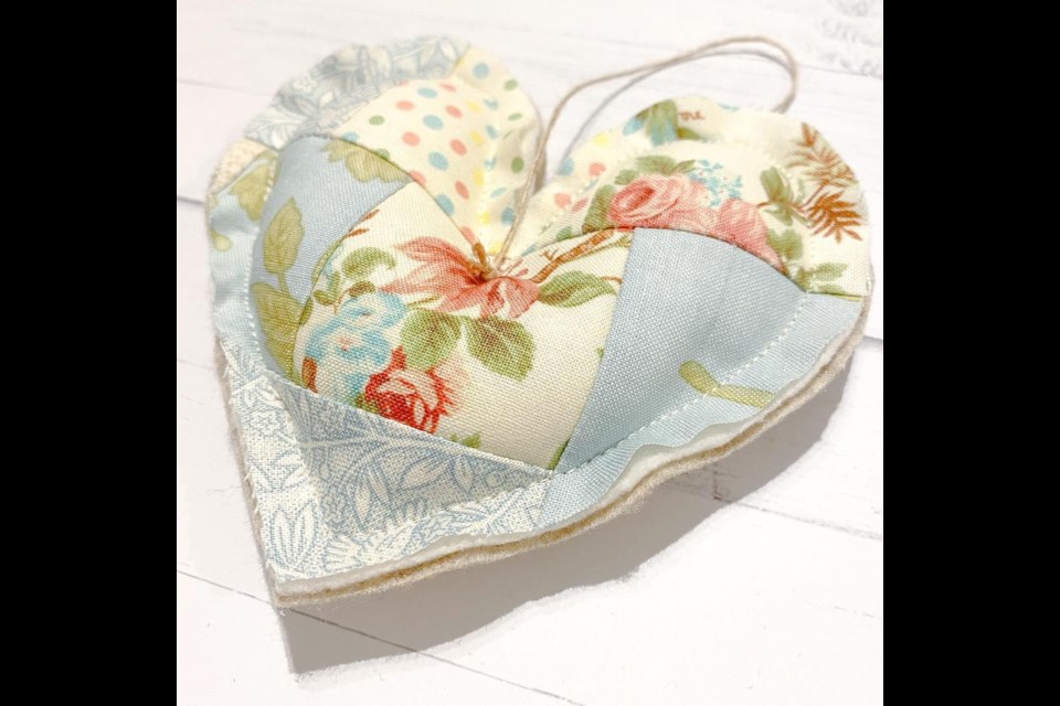 Liz Simpson's scrappy quilt hearts are made with scraps of vintage fabric imported from France.