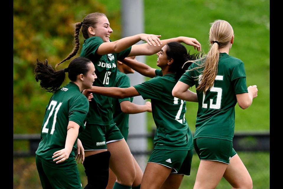 The Douglas College Royals celebrate a goal by Sarah Svetic in the first half during a matchup against VIU at Cunnings Field, in Town Centre Park in Coquitlam, on Oct. 22, 2023. 