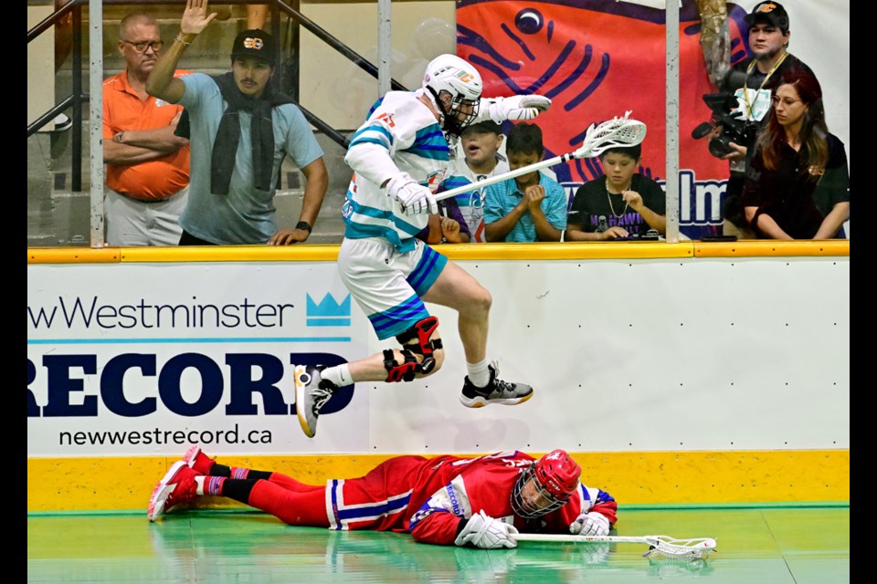 Kellen Leclair of the Six Nations Chiefs leaps over Mitch Jones of the Salmonbellies.