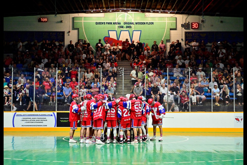 New Westminster Sr. A Salmonbellies gather at the net in front of a packed Queen's park arena.