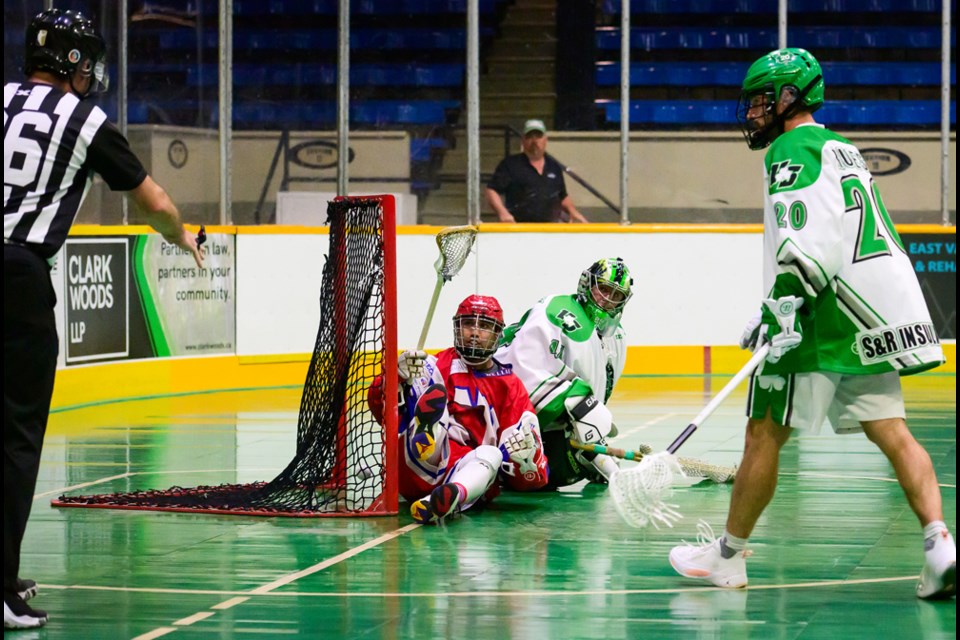 Keegan Bal sits in the net with the ball as the New Westminster Salmonbellies defeated Victoria in a semi-final match at Queen’s park on Aug. 2, 2023.
Photo: Jennifer Gauthier