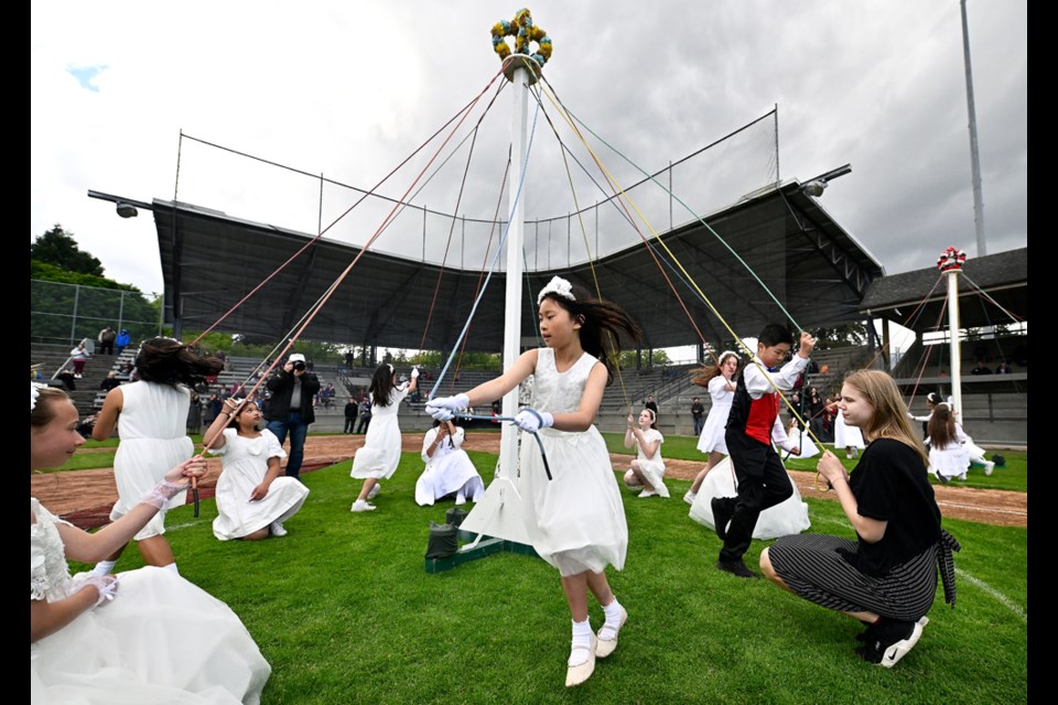 Maypole dancing at the 154th May Day at Queen park stadium.