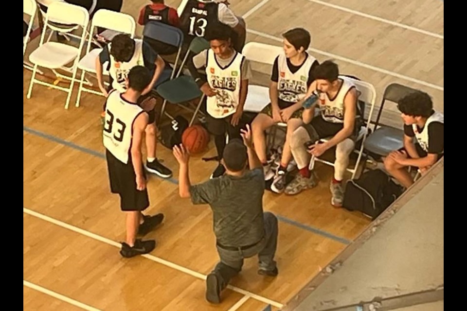 The New West Eagles youth basketball program huddles up during a timeout.