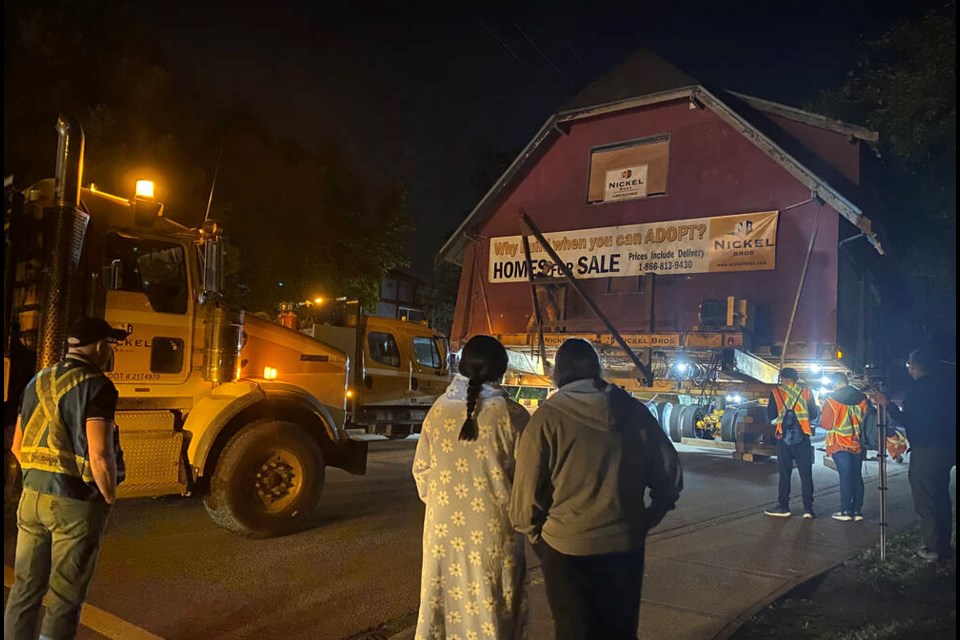 Residents gathered at the corner of Richmond and Cumberland streets, at the top of the Cumberland hill, at about 2 a.m. to watch as the house was levelled before resuming its journey. Photo Julie MacLellan 