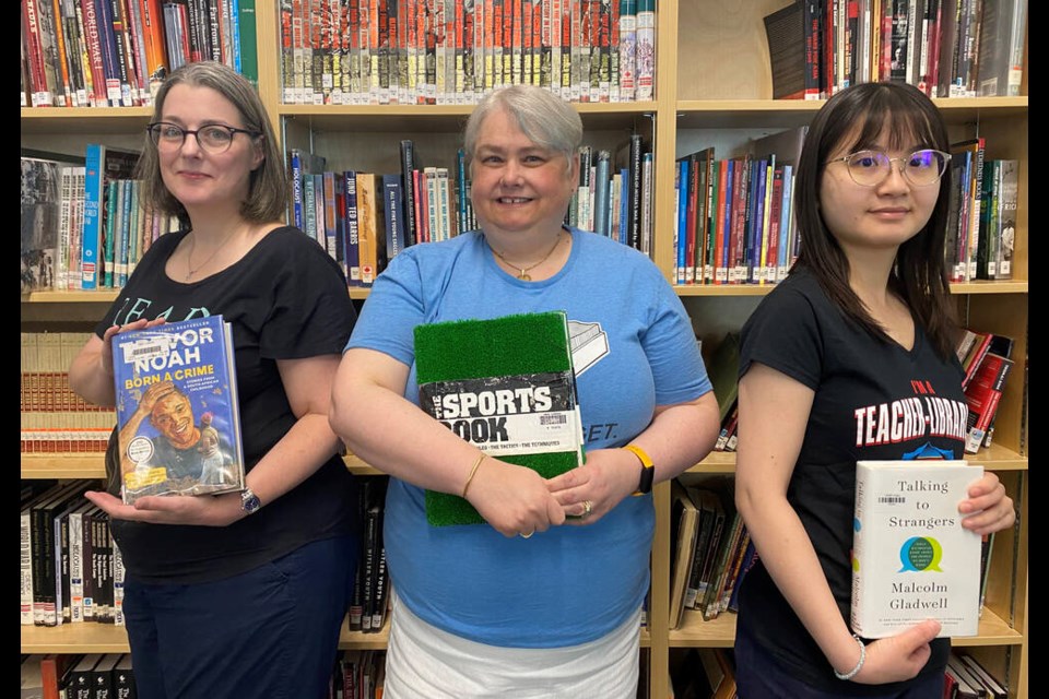 Towards inclusion: Teacher-librarians (from left) Lisa Seddon, Sarah Wethered and Jenny Chang are undertaking a year-long project to switch the NWSS library's non-fiction collections from the Dewey decimal classification system to the Brian Deer system.
Photo Julie MacLellan