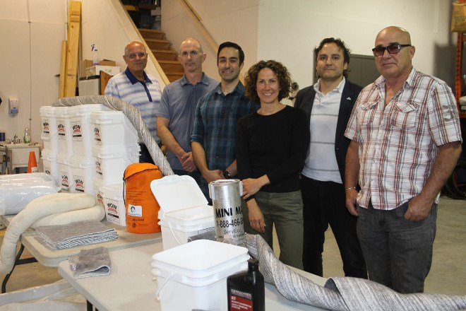 From left, Perry Mulligan, Steve Fava, Andre Legault, Joanna Kent, Dr. Dennis Reich and Jake Menard, the team behind the creation and marketing of Activated White, pose for a photo with their product line they are working on to sell to industrial buyers at their NORCAT location on June 15.