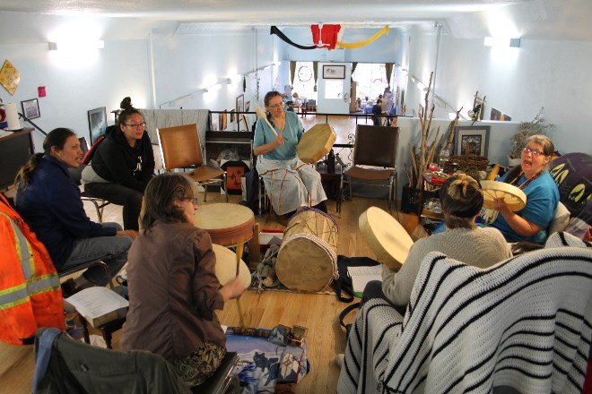 Cindy Crowe, right, seated on the couch, drumming, leads a drum circle I the loft of Blue Sky  Community Healing Centre while a Learn to Paint class does on on the main floor of the Victoria Avenue centre. Crowe also is the proprietor of One Tribe Indigenous Worldview and Diversity Coaching to help businesses and government agencies have a better understanding of First Nations cultures. The centre and services, Crow says, are being well received and helping to attract businesses back tot he south end downtown core. 