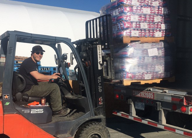 A shipment of donated pet food is unloaded at North Star Air's base in Pickle Lake. (Ontario SPCA photo)