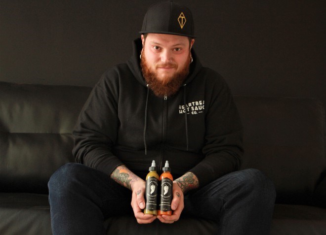 Al Bourbouhakis, co-founder of Heartbeat Hot Sauce Co., with two of its signature sauces, Green Jalapeno and Red Habanero, in Thunder Bay. (Karen McKinley photo)
