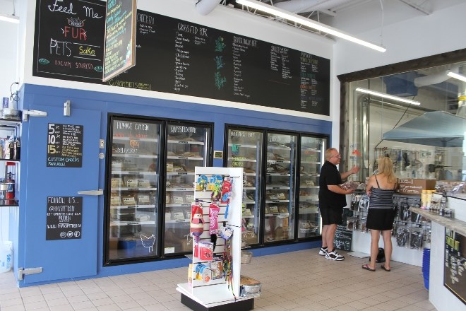 The interior of Max's Deli is open concept, with a giant freezer containing all their cooked and packaged food and raw treats.