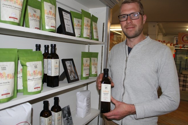 Jeff Burke at his kiosk at the Thunder Bay Country  Market on Oct. 24, where he sells a wide range of products, including flour, cake mixes and his own canola oil.