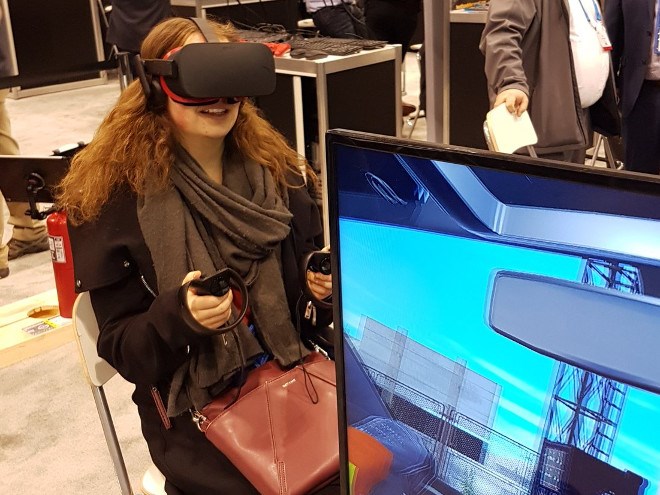 Mining reporter Kelsey Wolfe tries her hand at NORCAT’s VR surface mine tour technology at the PDAC mining show in Toronto (Twitter).
