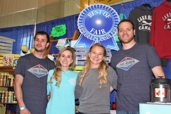 From left, Ryan Keller, Ashleigh Moffatt-Keller, Spencer Kenney and Jennifer Moffat-Kenney pose in their booth for Island Outfitters, a newly formed business that is a merging of Island Adventure Outfitter and Island Home Outfitters. 