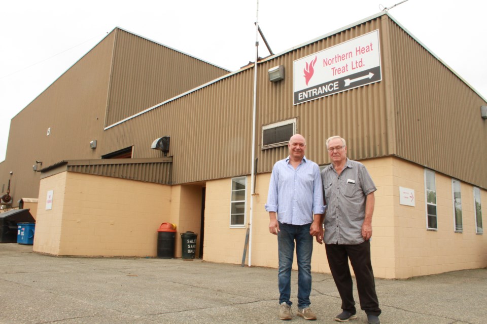 George Sidun Jr., left, and George Sidun Sr. outside the new Northern Heat Treat Ltd., building in the former NRE complex in Capreol. 