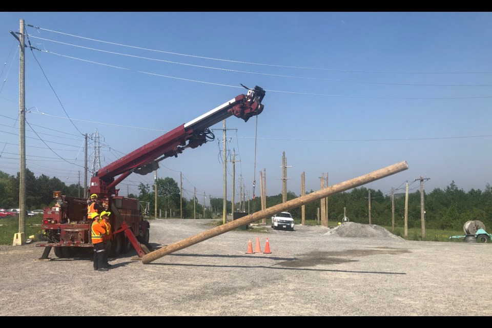 Students enrolled in Cambrian College's powerline technician program use a digger derrick truck.  (Angela Gemmill photo)