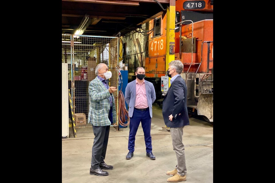 Provincial Finance Minister Rod Phillips (r) chats with Milad Mansour (l) and Jason Carriere at the Diesel Electric Services locomotive shop in Sudbury.(Supplied photo)