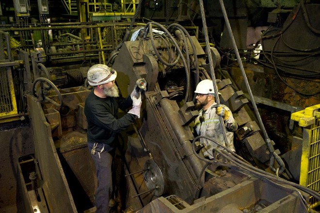 Workers install overhauled mandrel piercing mill stands during a four-week August maintenance shutdown at Algoma Tubes in Sault Ste. Marie (Tenaris Facebook photo)