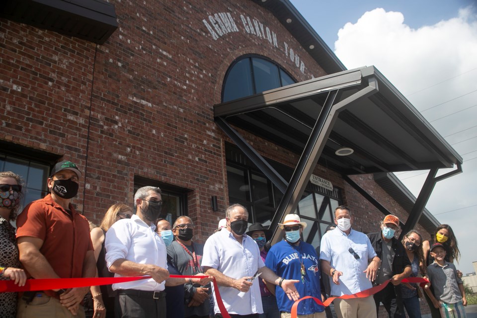 A ceremonial ribbon is cut by Tony Porco and other dignitaries during a celebration at the newly-constructed Agawa Canyon Tour Train station in the Canal District. Kenneth Armstrong/SooToday 