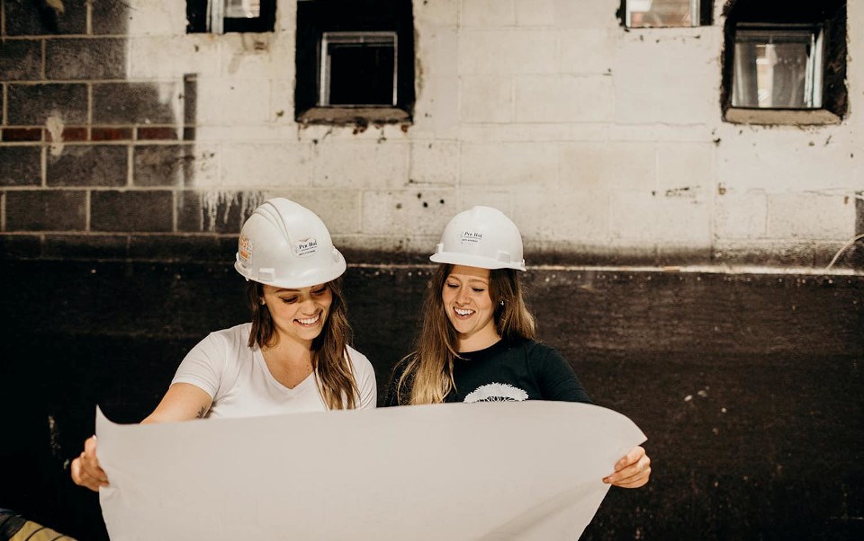 Hailey (in white) and Bree (in black) Hollinsworth, at the site of Ungalli’s new
warehouse and retail space, in the former Cumberland Cinema in Thunder Bay, Revitalizing the
Port Arthur Neighbourhood. Photo credit: Jamie Dawn Olsen.