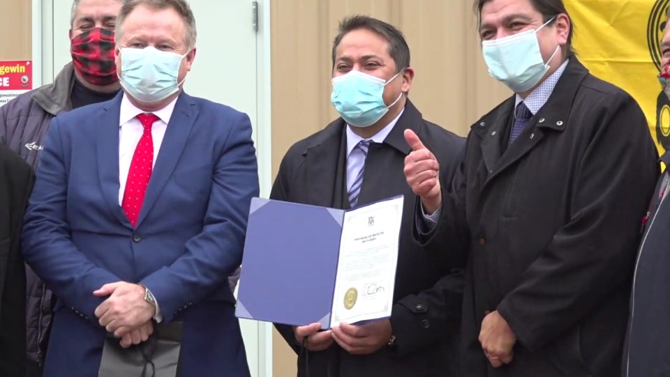 From left, Dent-X Canada president Jimmy Emms, First Nations Procurement Inc. president Matthew Owl, and Wiikwemkoong Chief Duke Peltier celebrated the official opening of a new FN95 mask manufacturing facility on Nov. 26. (Screen capture courtesy FirstTel Communications Corp.)