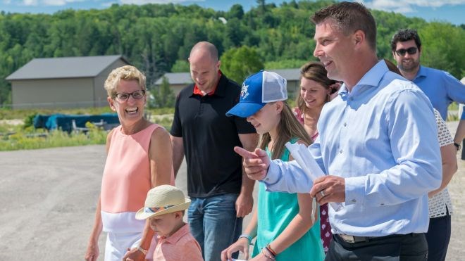 Jeff Scharf (foreground), president at Greenhouses Canada, leads Ontario Premier Kathleen Wynne (left) on a tour of his Espanola greenhouse facility in August. Photo supplied