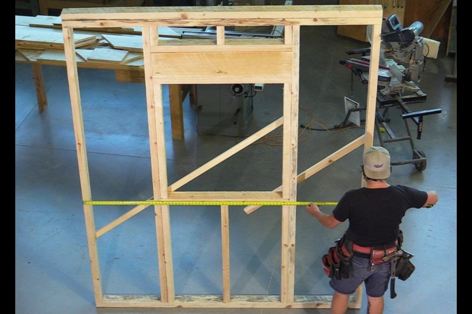 Jérémie Roy, a Collège Boréal architectural technology student, builds a wall to install and test an insulated shutter. (Supplied photo/Collège Boréal)