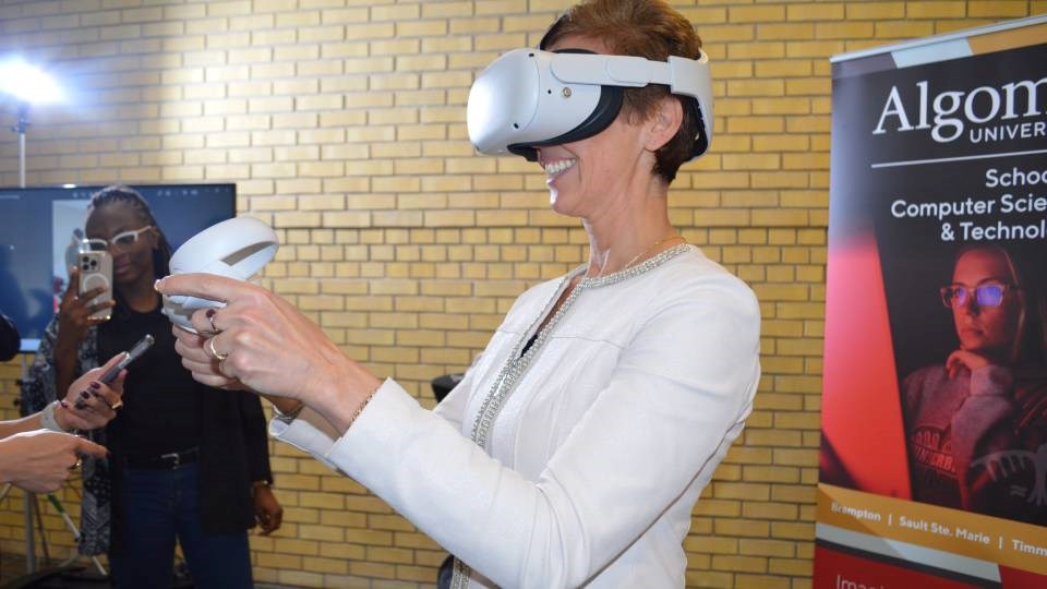 Algoma University president Asima Vezina trying the latest virtual reality (VR) technology during the school's announcement of its partnership with Unity. 