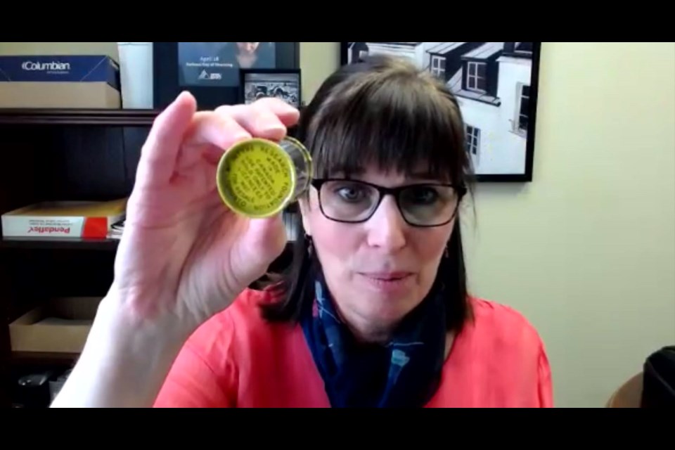 Janice Martell displays a canister of finely ground aluminum dust called McIntyre Powder during a Sept. 8 webinar discussing the impact of the substance on miners and other industry workers.
