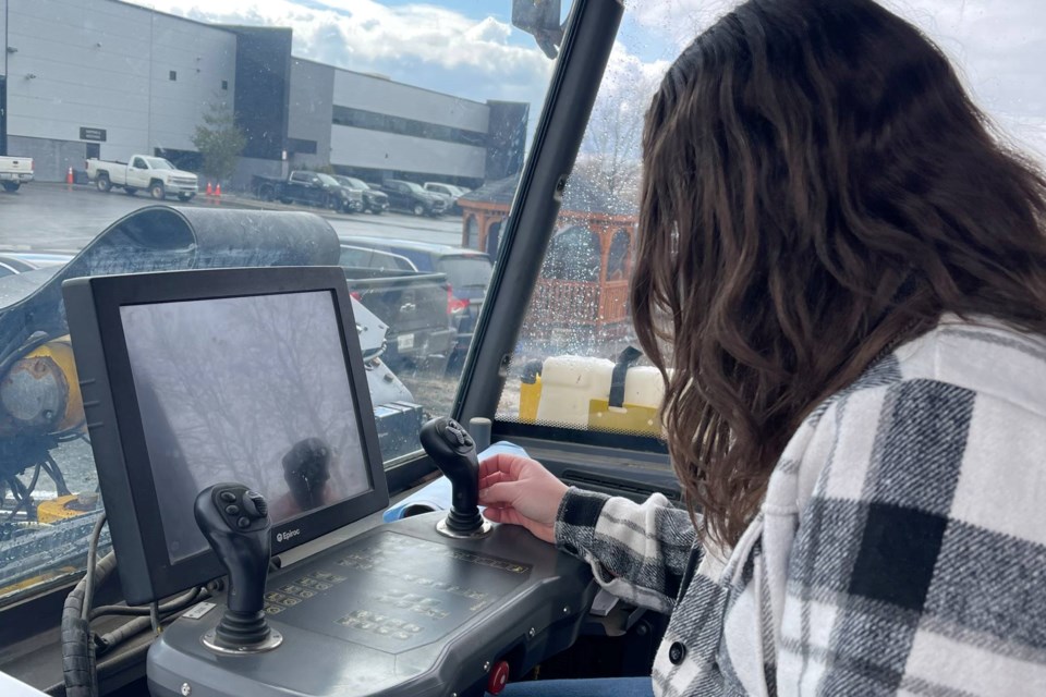 New software being developed by Sofvie, Inc., requires a worker to have the proper training to operate heavy machinery underground. Jazmyn Zarichney, a junior data analyst with Sofvie, demonstrates the technology.