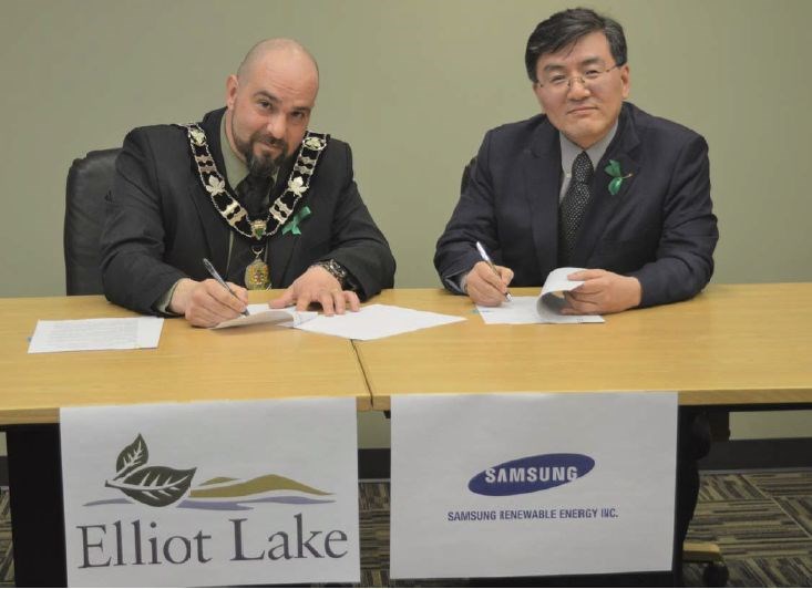 Elliot Lake Mayor Dan Marchisella (left) and Samsung Renewable Energy president Eskay Lee signed a memorandum of understanding on April 11 that will form the basis of an agreement to produce and store renewable energy for the city’s facilities. (Submitted photo)