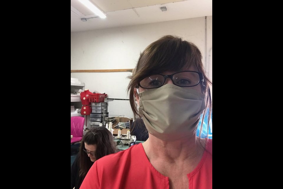 Julie Gohm,  of The Original  Bug Shirt Company in Powassan, models a mask she's fabricated following requests during the COVID-19 pandemic. (Supplied photo)